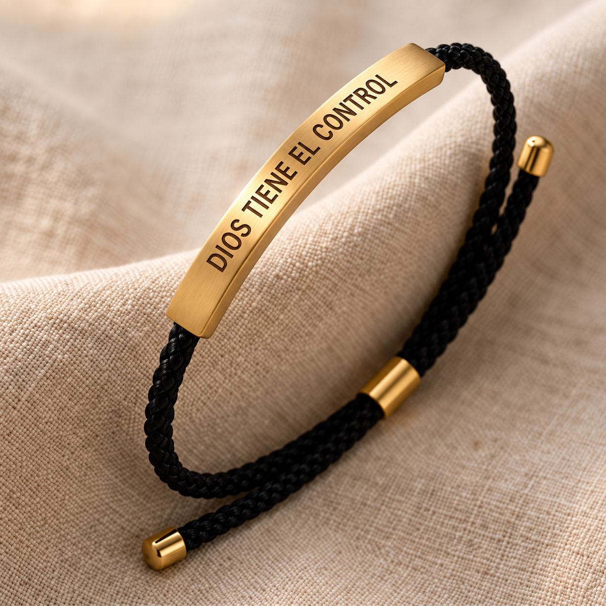 Close-up of the Dios Tiene el Control engraving and woven cord